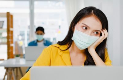 freelance asia women wear face mask using laptop hard work new normal home office working from house overload self isolation social distancing quarantine corona virus prevention 7861 2604 e1602557286734