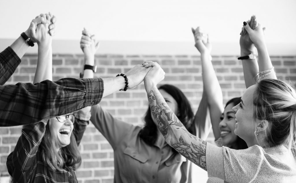 business team hands raised with successful